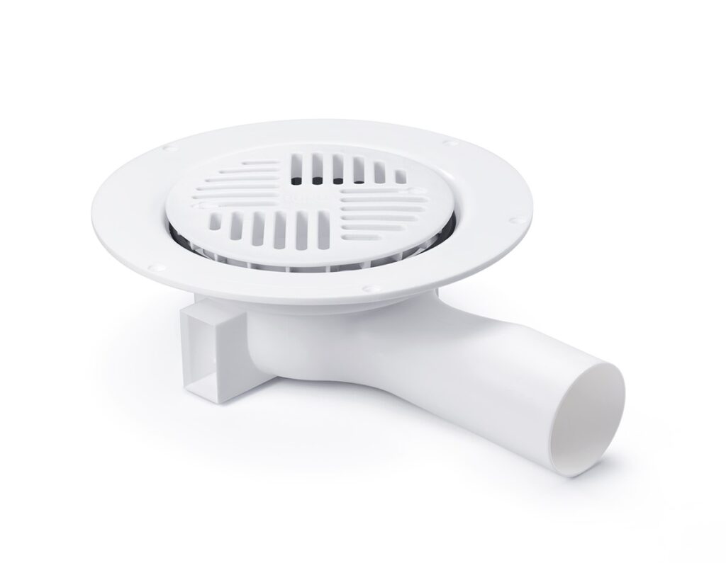 White plastic floor drain with a horizontal outlet and a grate.